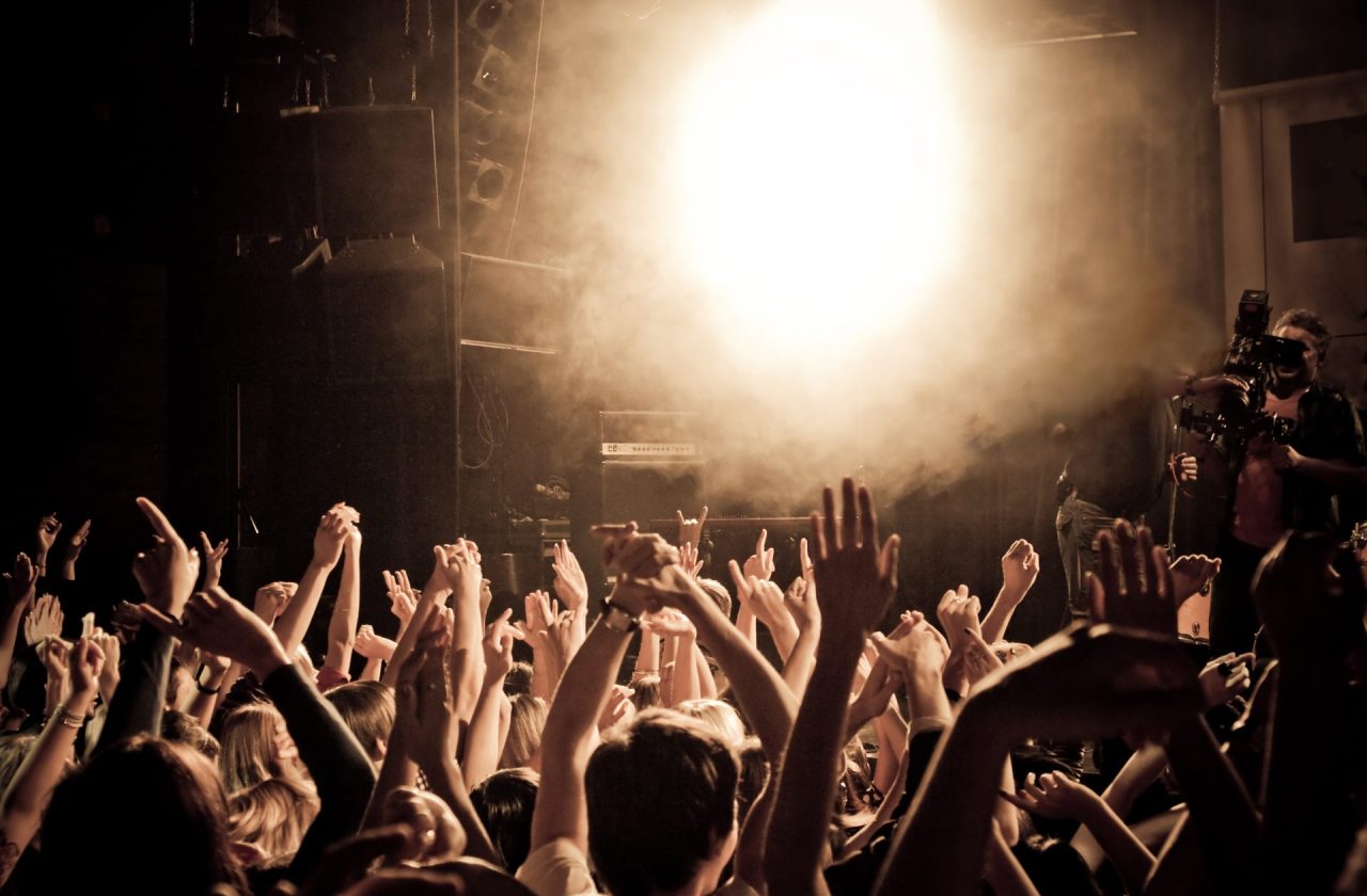 Cheering crowd People at a concert waving hands