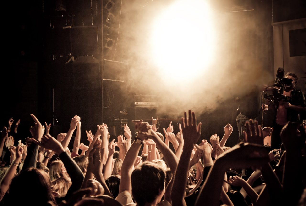 Cheering crowd People at a concert waving hands